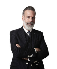 Portrait of bearded gentleman wearing trendy suit and stands against the empty white wall. Vertical