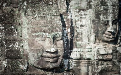 Huge stone faces and human figures carving in Cambodia