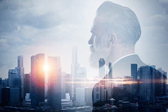 Double exposure of stylish businessman and contemporary city on the background. Horizontal, close-up