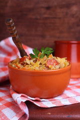 sauerkraut with sausage and lentils in a clay bowl