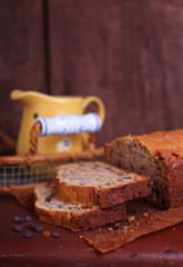 Apple cake with walnuts on a brown background