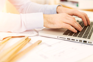 Close up view of an architect working at office