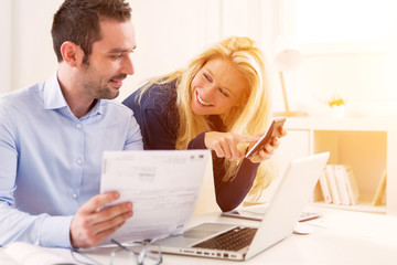 Attractive couple doing administrative paperwork
