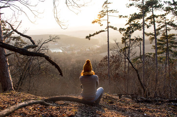Girl sitting  in forest with beautiful view