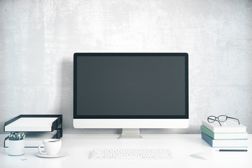 Blank black computer screen with office accessories on white tab