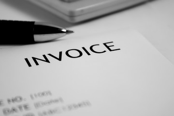 Invoice letter head with pen and calculator / selective focus