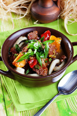 Lagman with meat clay pot wooden board still life green bright beautiful appetizing, delicious food