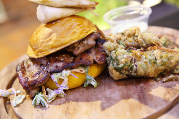 Chicken burger with fried vegetables