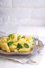pasta with broccoli in a gray vintage plate on a white background