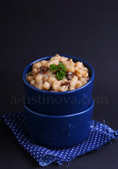 barley porridge decorated with a green leaf in a blue plate