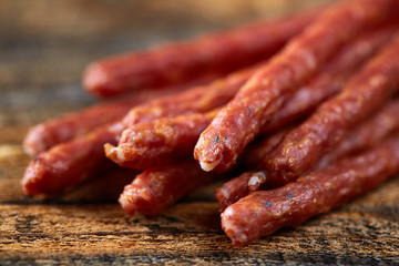 Sticks sausages on wooden board