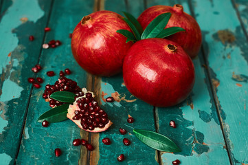 Pomegranate on the old wooden background. Rustic still life.
