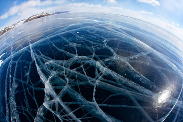 Winter ice landscape on Siberian lake Baikal with clouds