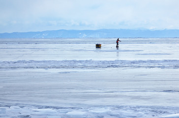 Tourist traveling on Baikal Lake in Siberia at winter