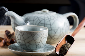 Traditional cup of steaming tea with accessories for infusion