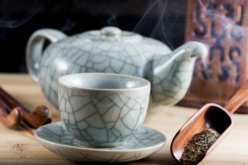 Traditional cup of steaming tea with accessories for infusion