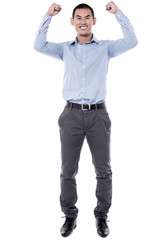 Cheering young man against a white background