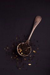 Big leaf tea strainer inside vintage ( spoon ) on the black background