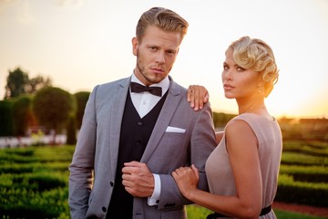 Well-dressed couple in a beautiful park