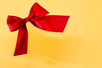 red bow on golden background - copy space for text