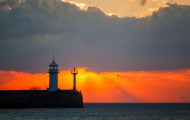 Beautiful sunrise over a beacon in Yalta, the Crimea