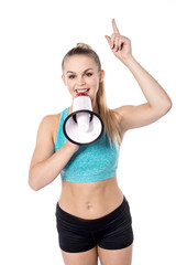 Fit lady posing holding megaphone