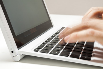 Closeup of businessmen hand fast typing on laptop keyboard