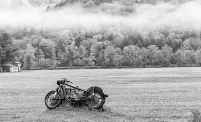 Abandoned motorbike on a meadow