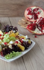 salad with quail eggs, cheese, pomegranate, orange