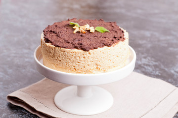 Cake of a souffle with glaze on a white plate.