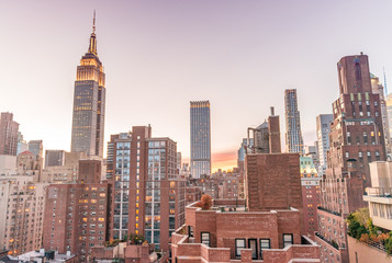 New York skyline from rooftop. Sunset over Manhattan - obrazy, fototapety, plakaty