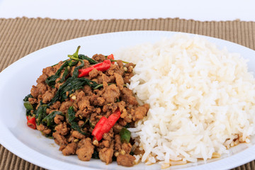 Rice topped with stir-fried pork and basil, fried stir basil with  minced pork on white background (isolated background)