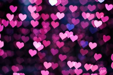 Blurring lights bokeh background of pink hearts