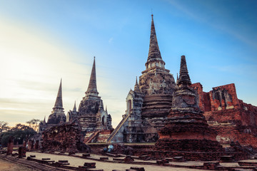 Fototapeta premium Asian religious architecture. Ancient Buddhist pagoda ruins at Wat Phra Sri Sanphet Temple in Ayutthaya, Thailand 