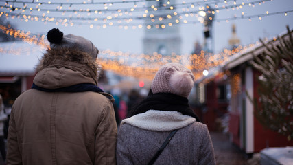 Young couple strolling during winter holidays