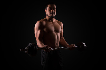Fototapeta na wymiar Muscular man at workout for his biceps