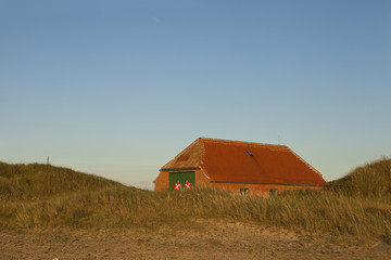 Lifeboat Hut Danish Style. The lifeboat stations in Denmark have the twin flag symbol on them to make them easily recognised. The lifeboat system has been in Denmark for over a century. 