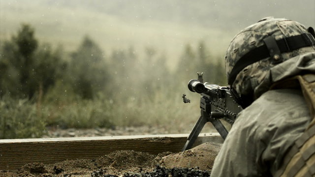 Super slow motion, soldier shooting chain gun.