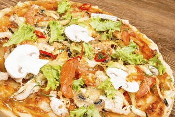 Pizza on dark wooden background. Stock image macro.