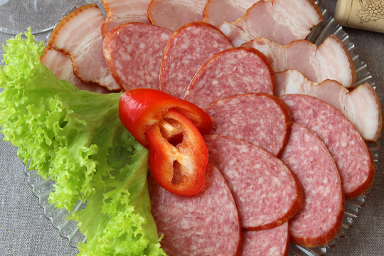 Plate of sausages, decorated with lettuce..