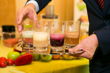 Glasses of juise with leafs and fruits