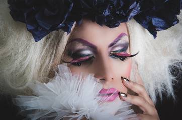 Drag queen with spectacular makeup, glamorous trashy look, posing happily and charming camera from...