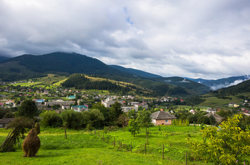 Mountain village before storm. Cloudy landscape