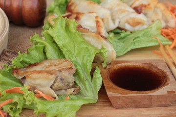 Fried gyoza and sauces - traditional Japanese food.