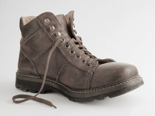 Old leather boot on a white background