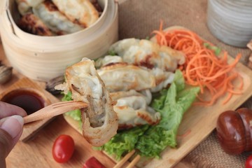 Fried gyoza and sauces - traditional Japanese food.