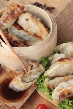 Fried gyoza and sauces - traditional Japanese food.