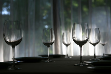 empty glasses at the table setting in the cafe in the backlight