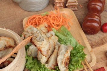 Fried gyoza and sauces - traditional Japanese food.