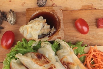 Fried gyoza and sauces - traditional Japanese food.